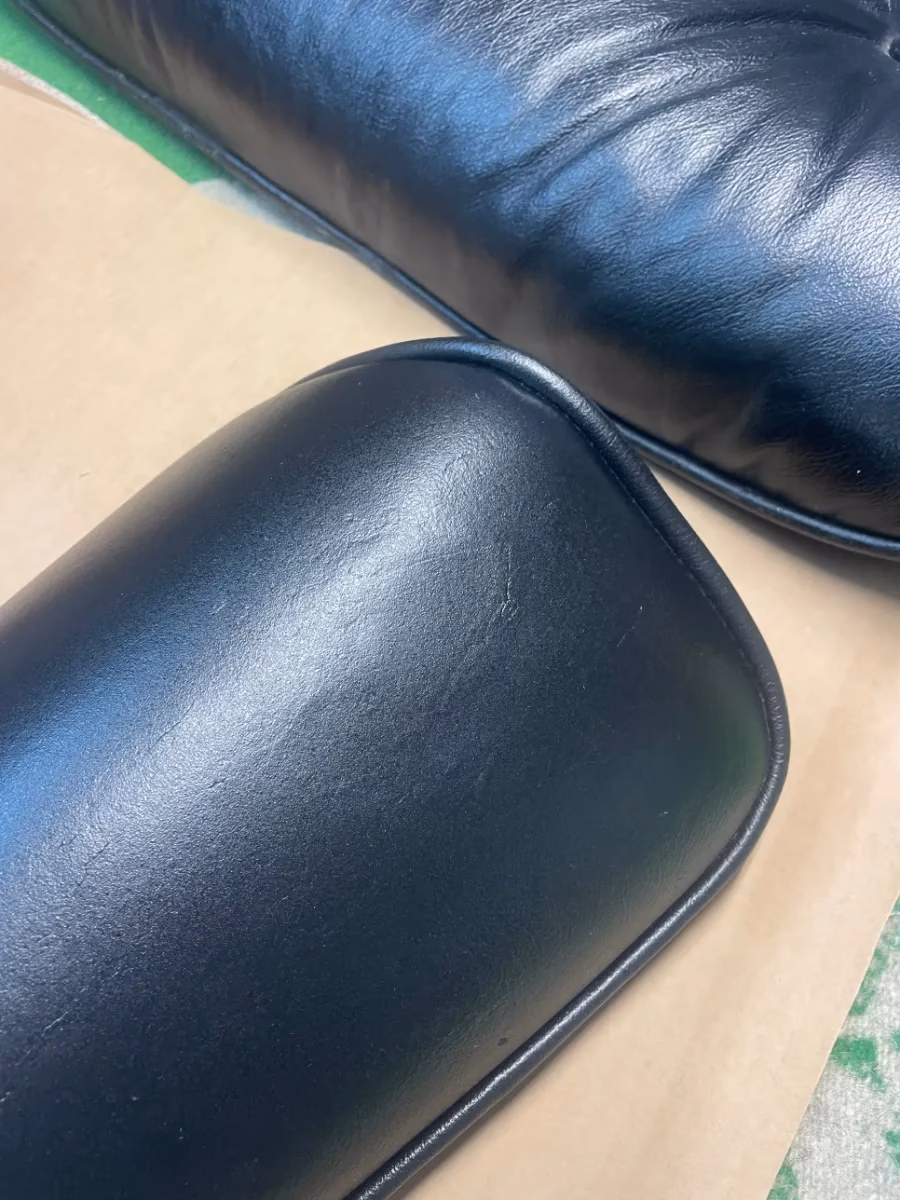 Black leather cushion after hole repair and refinishing by Apex Leather Repair