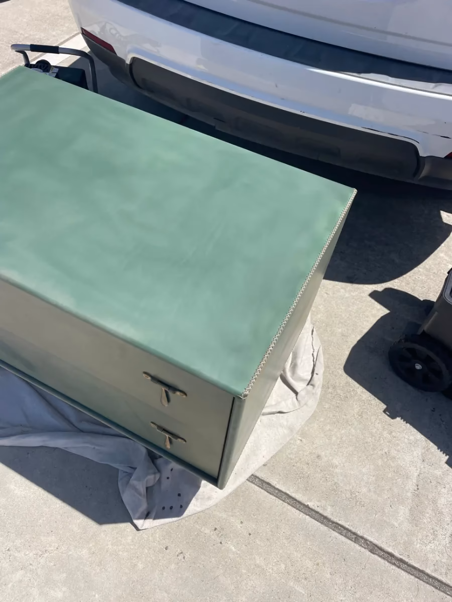 Green leather-covered chest after the top was refinished by Apex Leather Repair