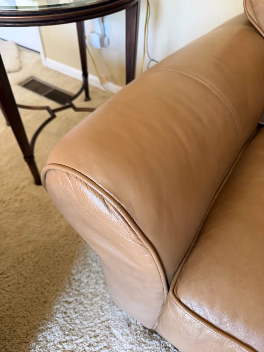 Tan leather sofa arm after tear repair and recoloring by Leather Repair Lab